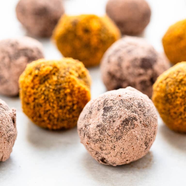 A batch of gingerbread truffles coated in cocoa or cookie crumbs.
