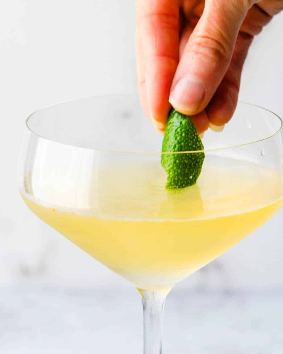 Garnishing a winter white cosmo with a bit of lime peel.