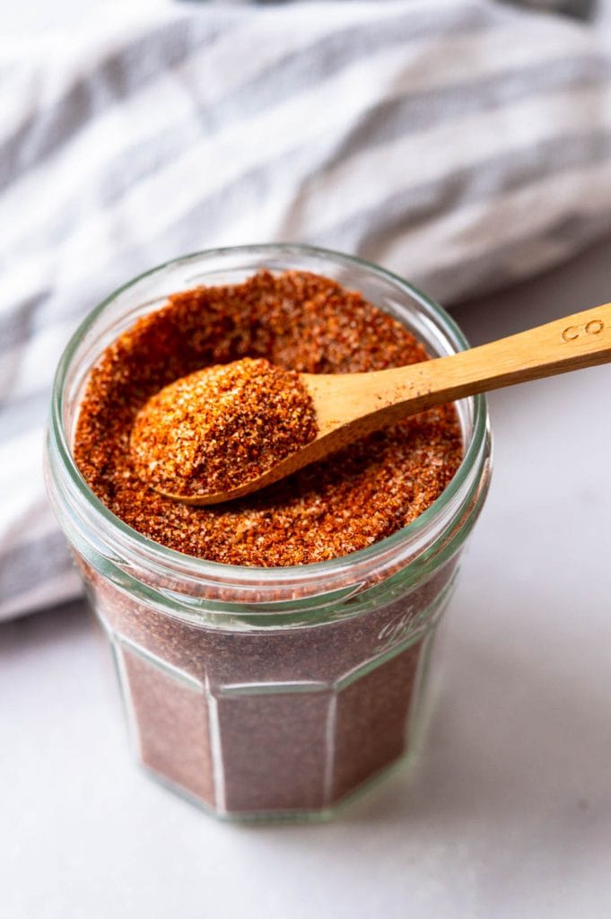 a spoonful of Kansas City dry rub in a glass storage jar.