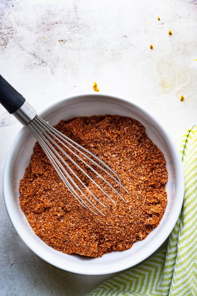 whisking sugar and spices in a bowl.