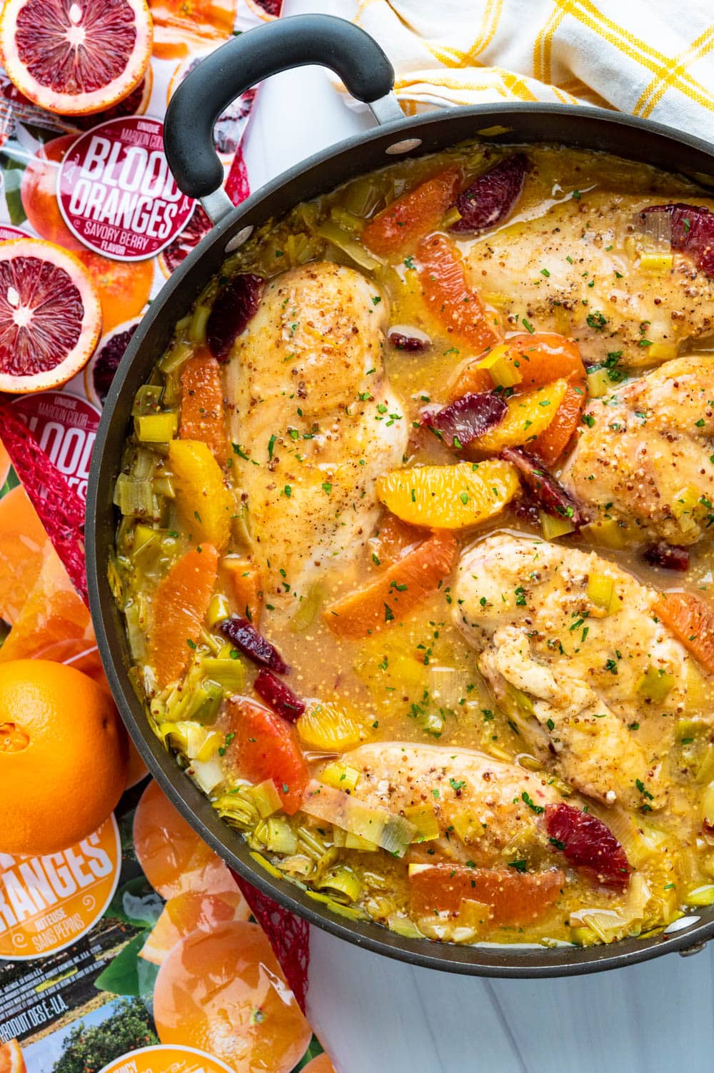 a pan of simmered orange chicken in a skillet. 