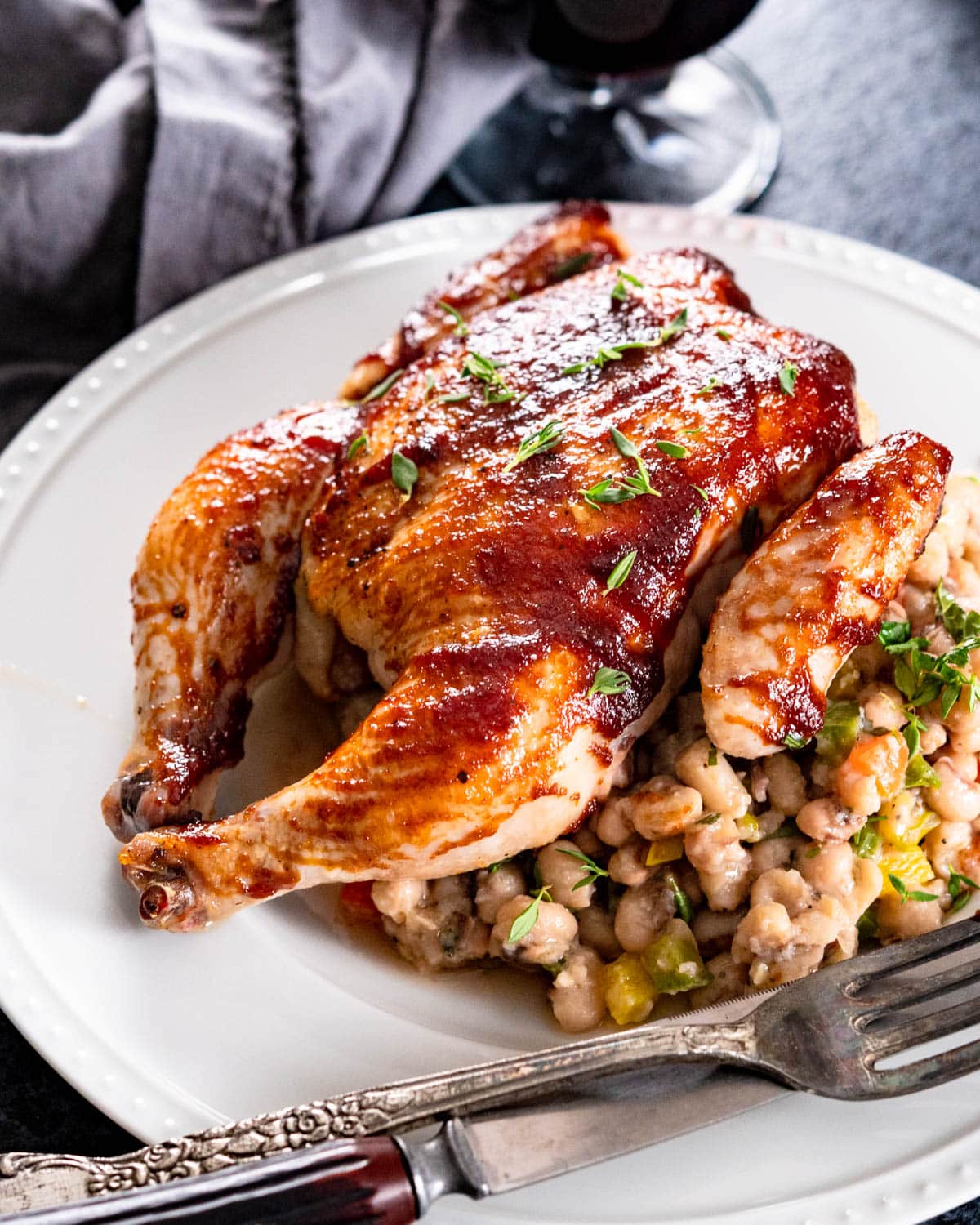 Serving a bbq poussin on a bed of beans.
