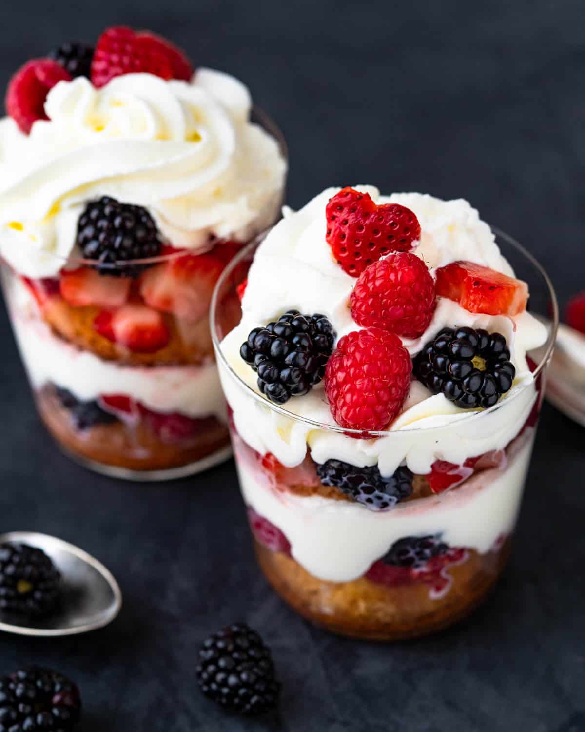 Two layered strawberry and mixed berry parfaits with mascarpone cream.