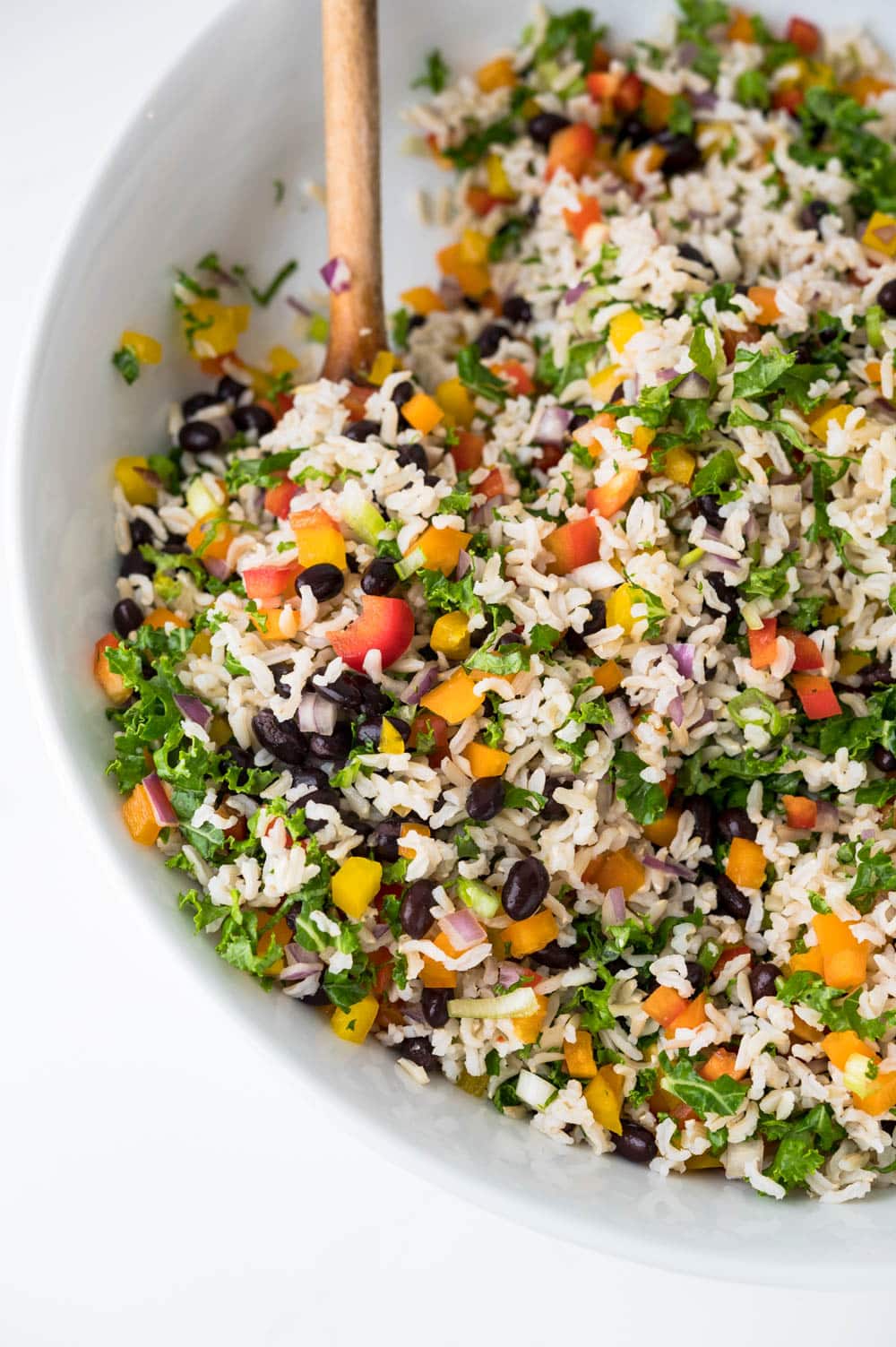 Serving black bean and brown rice salad in a large bowl.