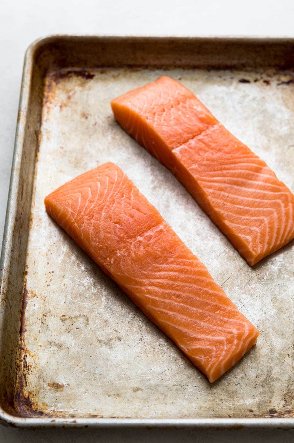 salmon fillets on a baking sheet.