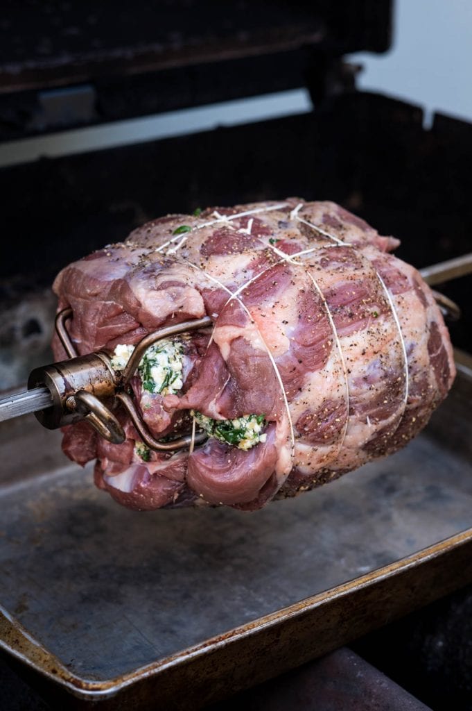 a rotisserie lamb resting on a cutting board.