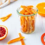 A small jar filled with candied citrus.
