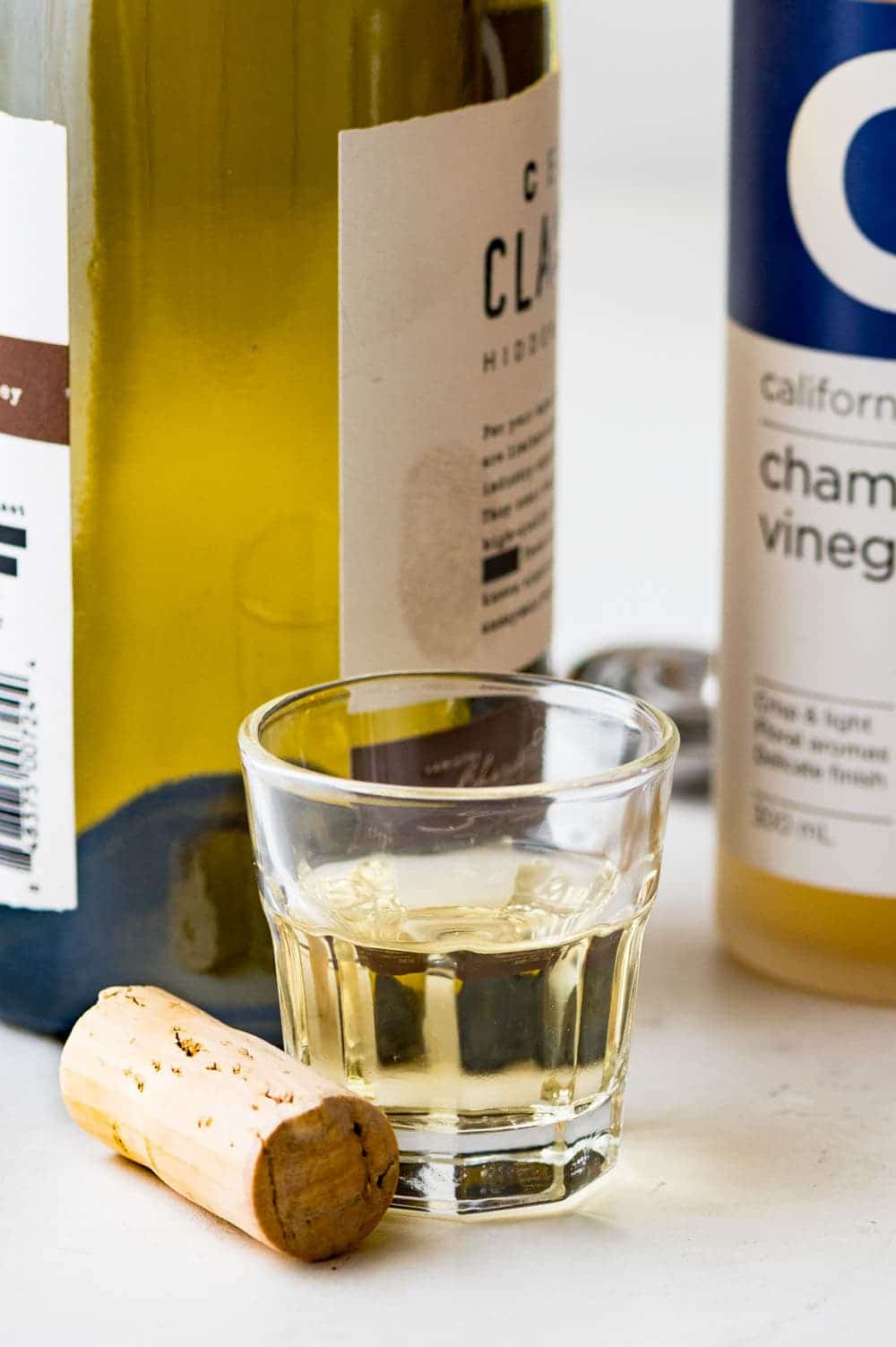white wine in a small glass with a cork.