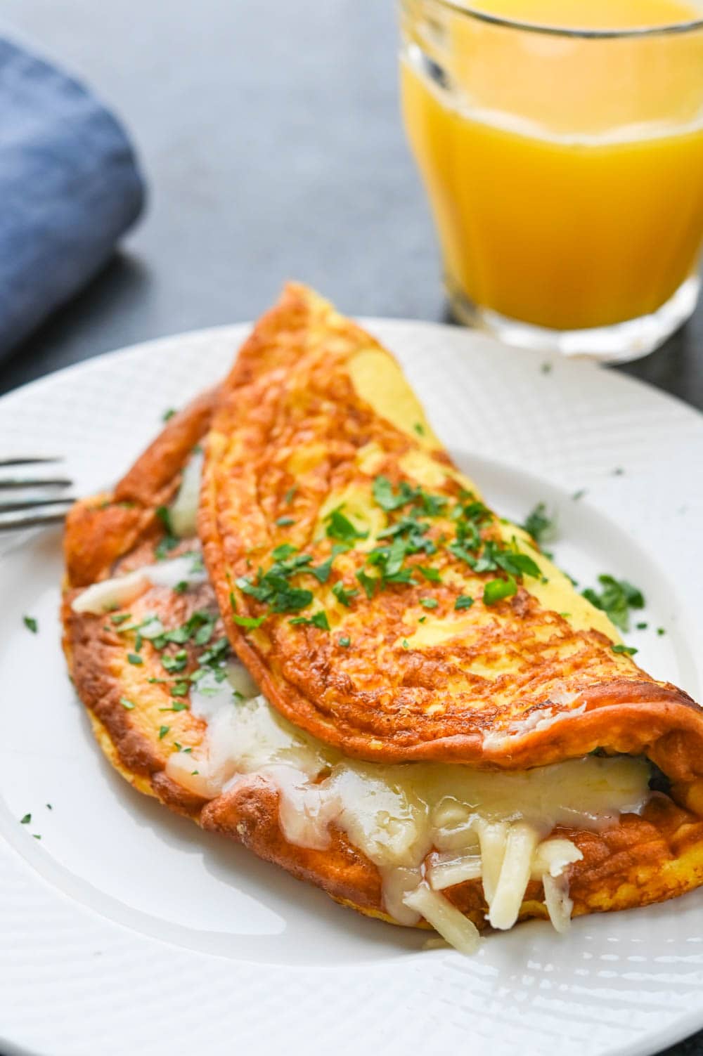 serving cheese omelette on a plate.
