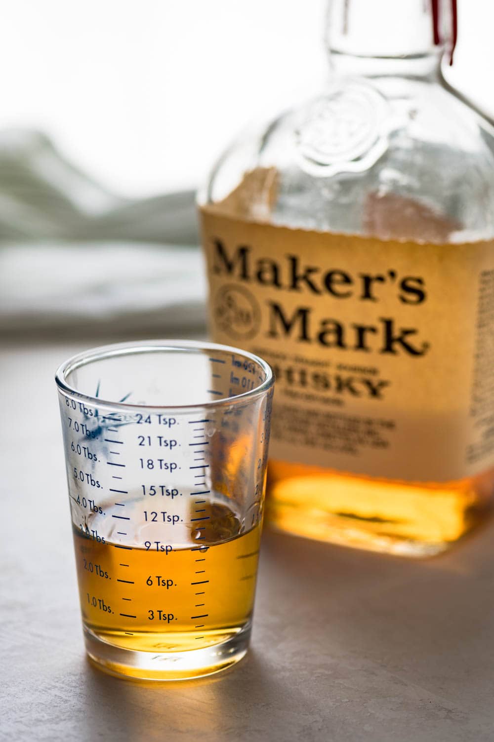 a bottle of Maker's Mark bourbon measured out to 3 tablespoons.