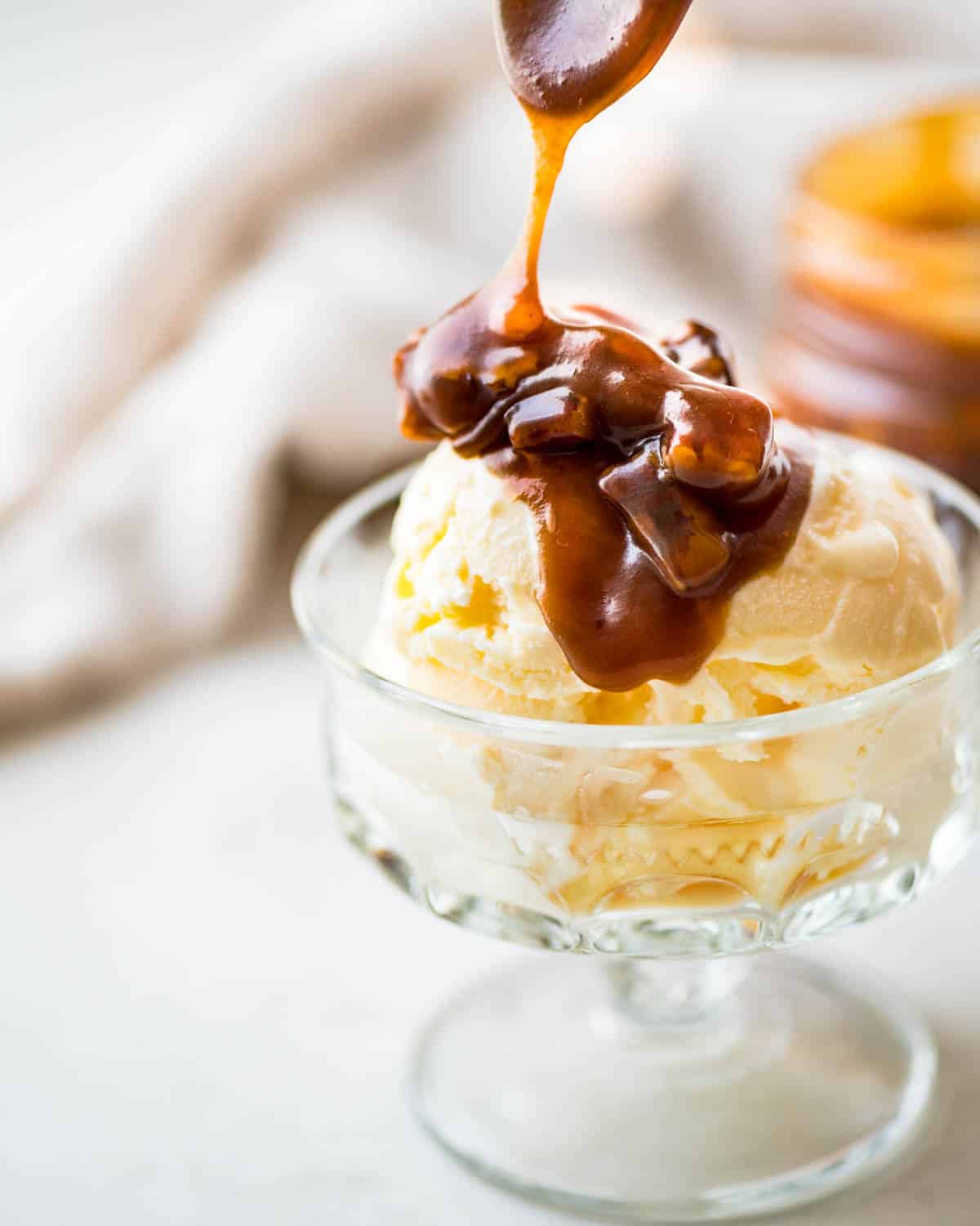 Drizzling Pecan Caramel sauce over a dish of ice cream.
