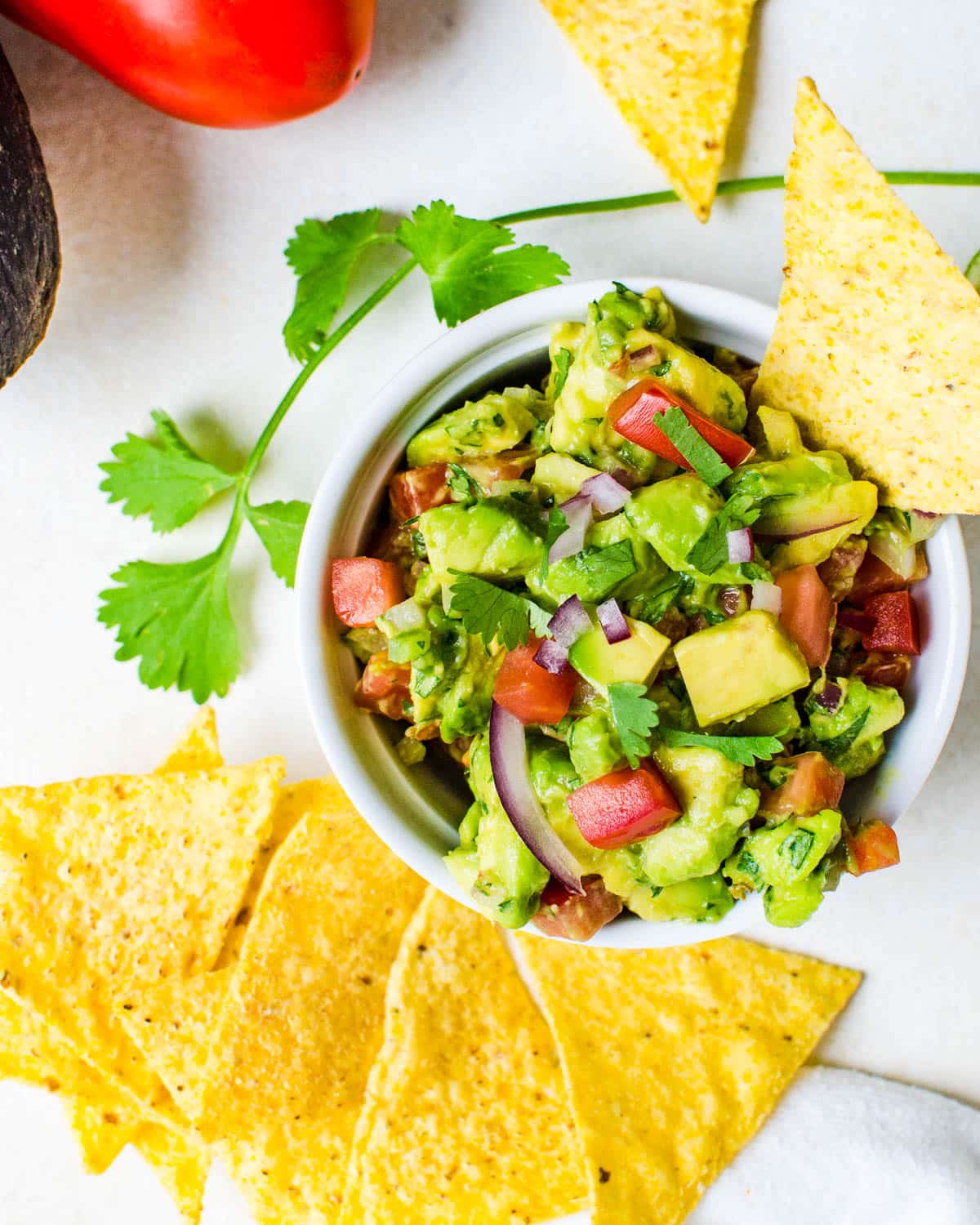 A dish of guacamole with crunchy tortilla chips.