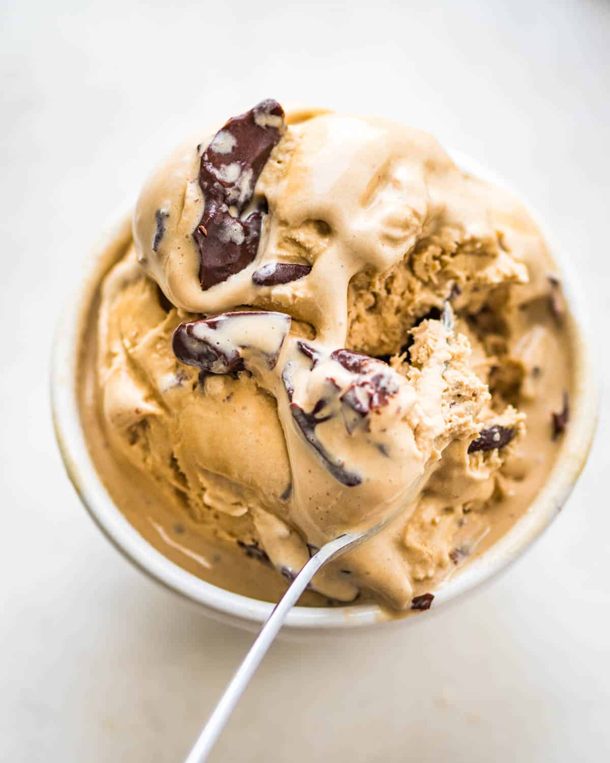 A bowl of espresso ice cream with chocolate chunks.