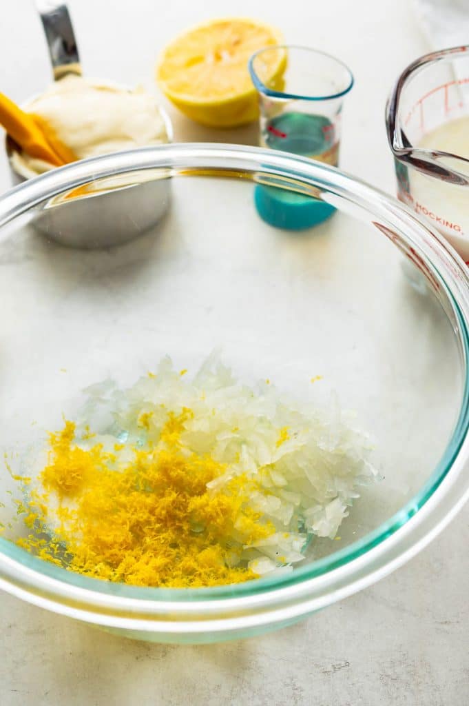 combining lemon zest and onions in a bowl.