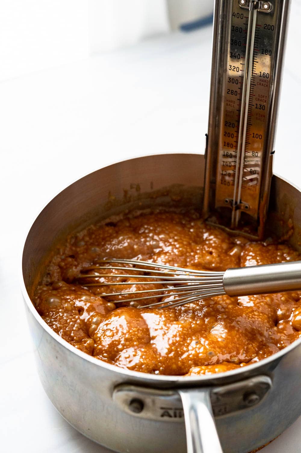 boiling the praline mixture and measuring with a candy thermometer.