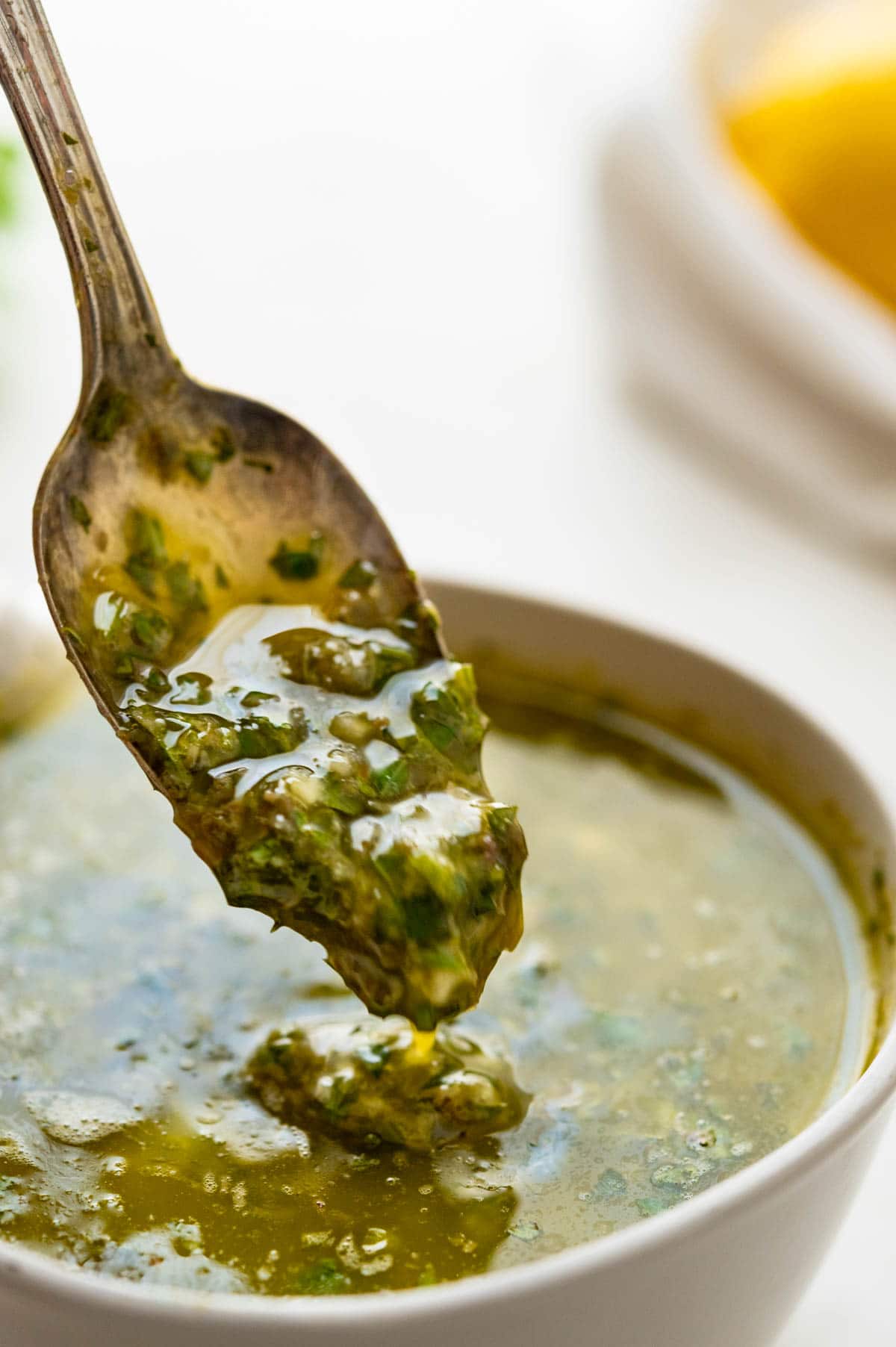 spooning up Italian Salsa verde with a spoon.