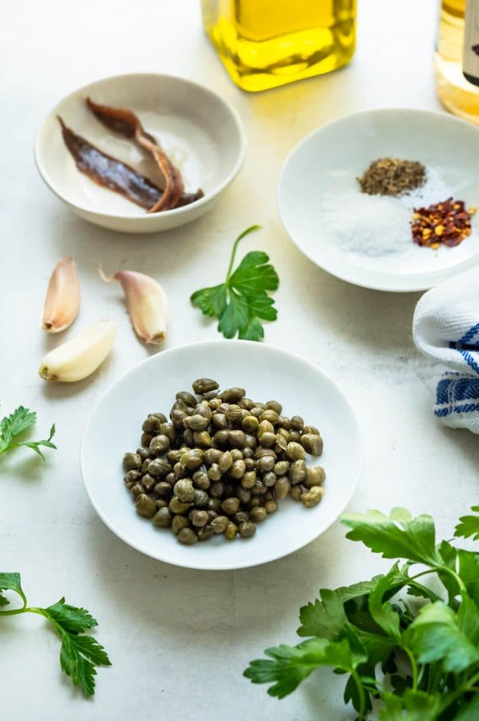 focus on capers and garlic for the Italian herb sauce.
