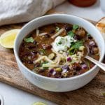 black bean chili with toppings in a bowl.