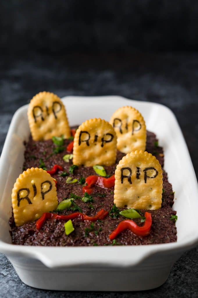 decorating the Halloween dip with "RIP" tombstones and pimento worms.
