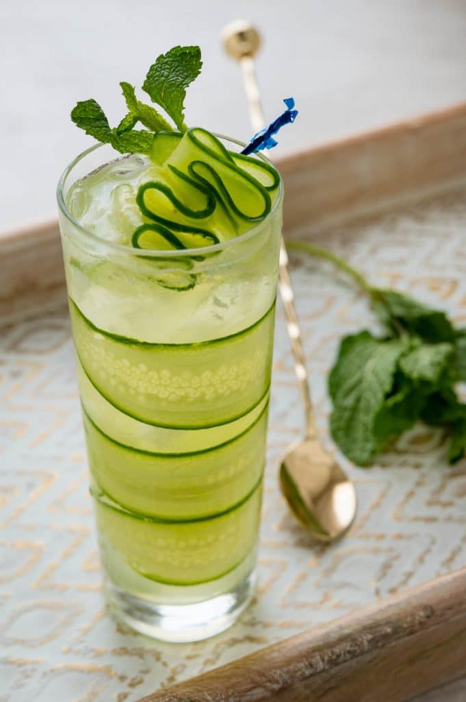 Serving a cucumber vodka cocktail on a pretty tray.