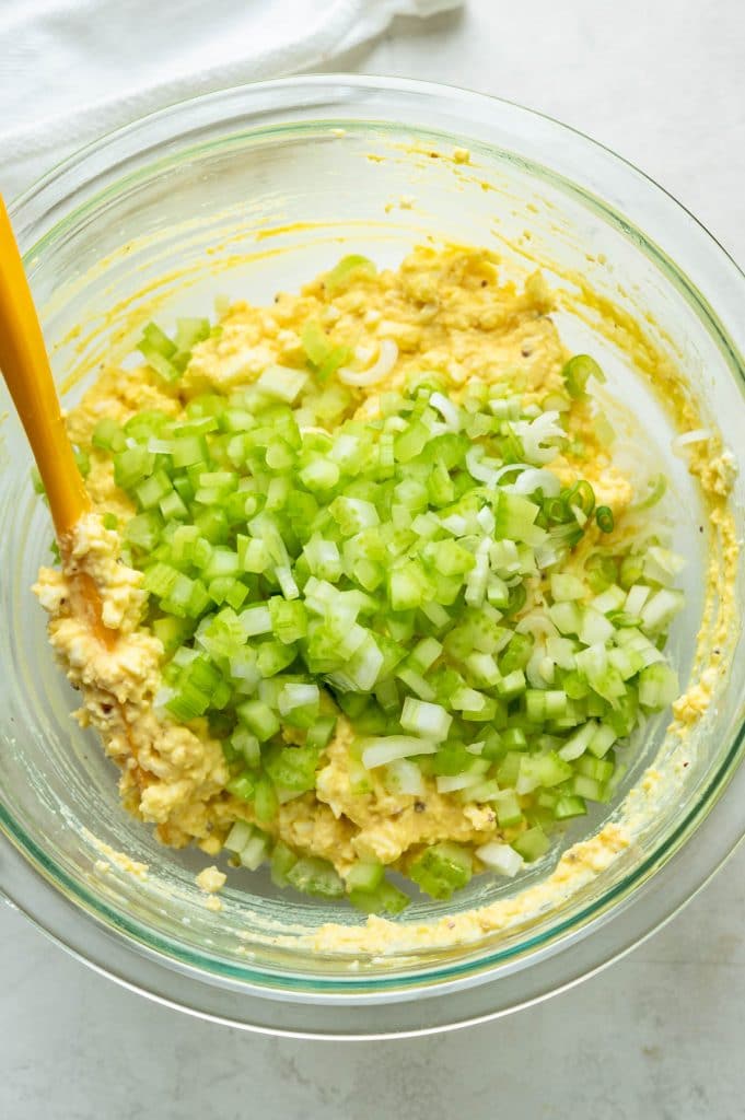 adding finely diced celery to the deviled egg salad.