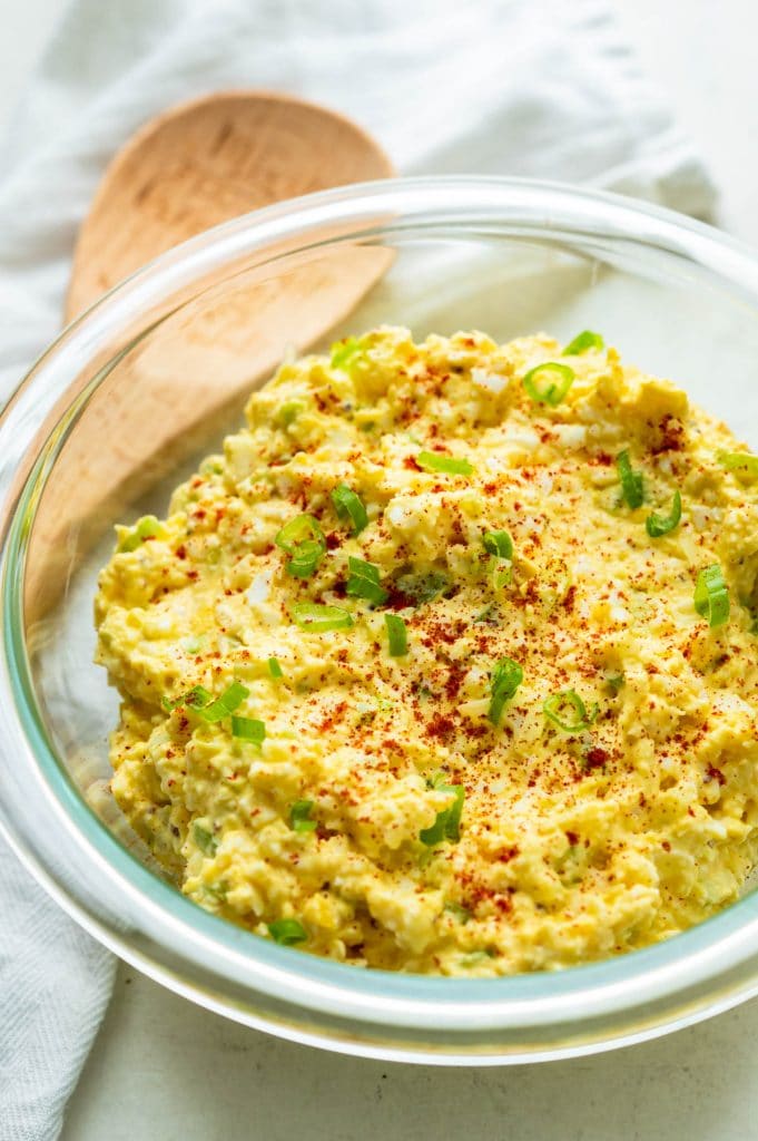 egg salad recipe, garnished with paprika and green onion.