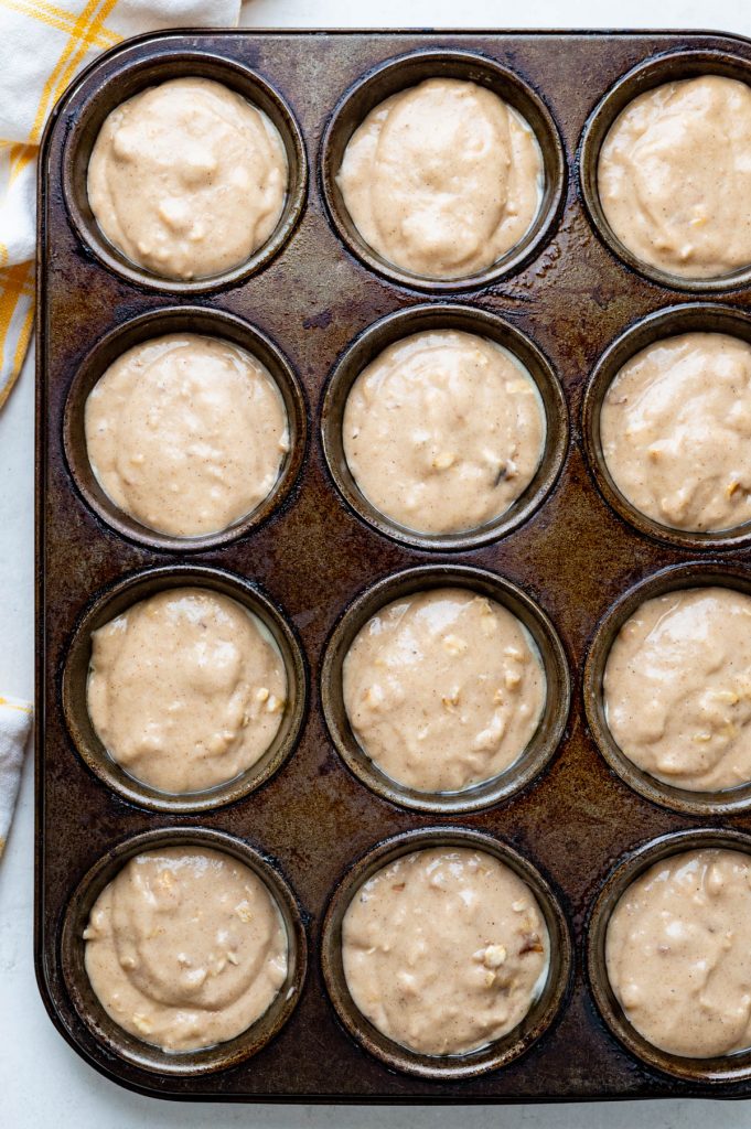 doling out the applesauce walnut batter into muffin tins.