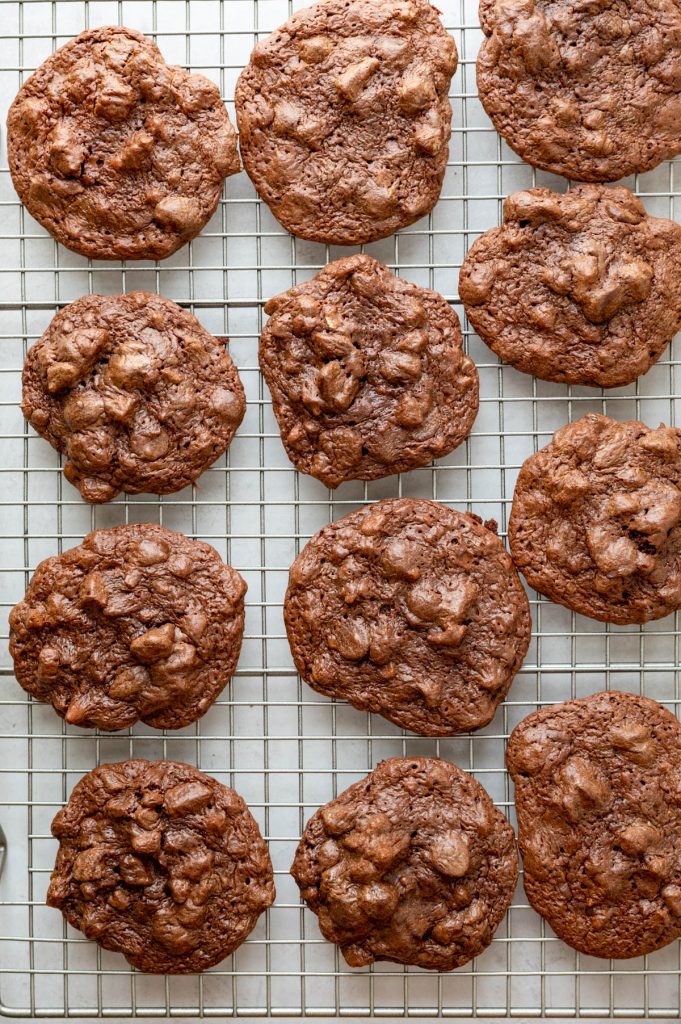 Cooling chocolate pecan brookie cookies on a rack.