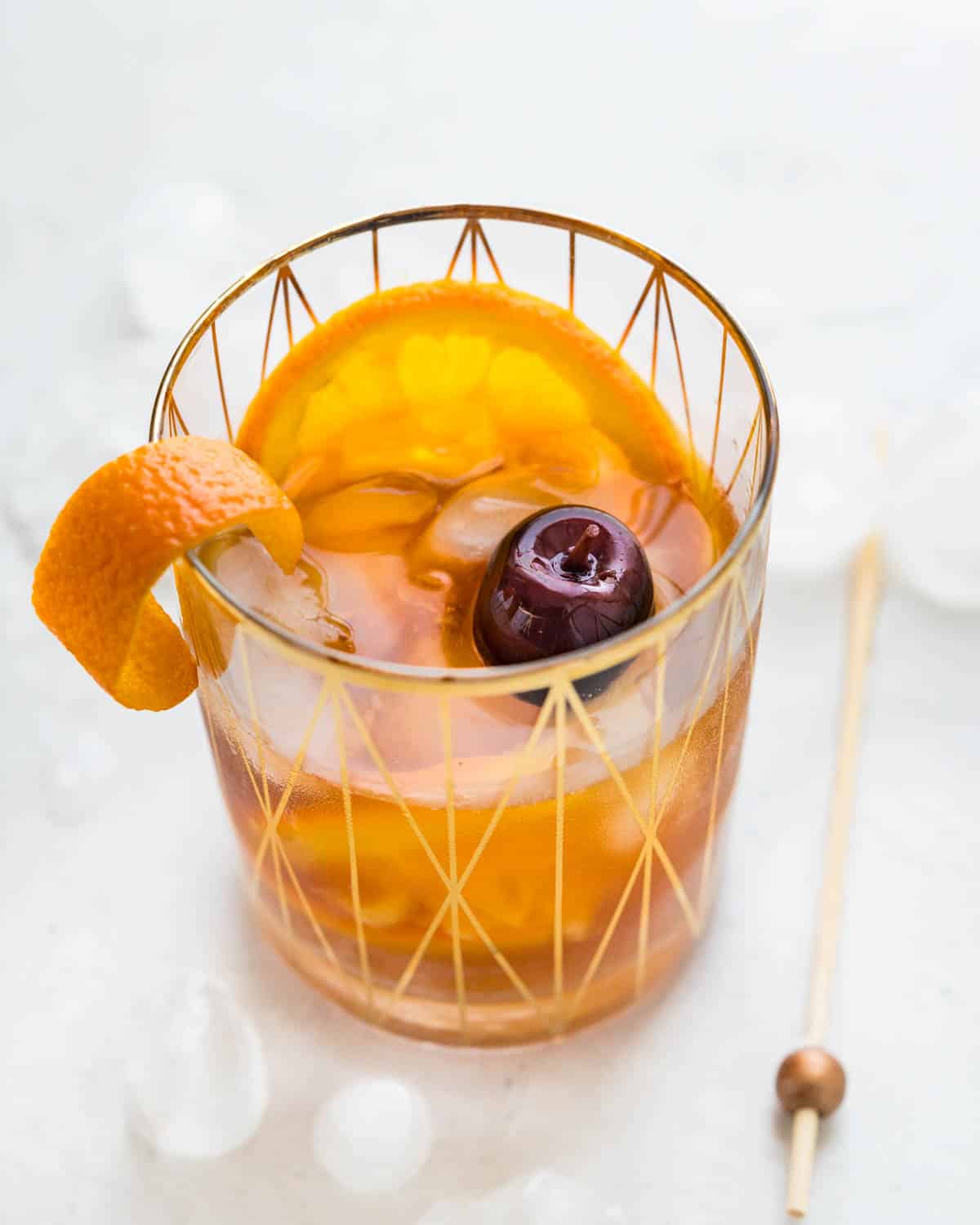 A Spiced Christmas Old Fashioned with Orange slice and amarena cherry.