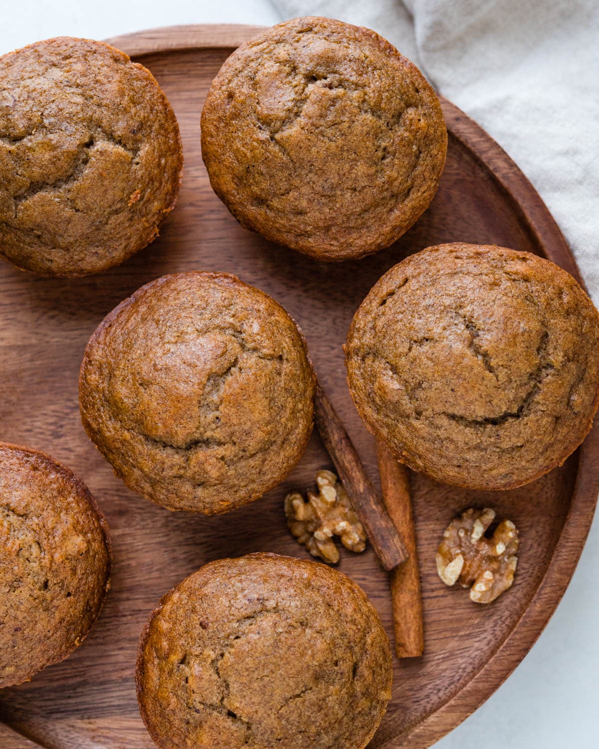 We are serving applesauce muffins on a wooden serving board.