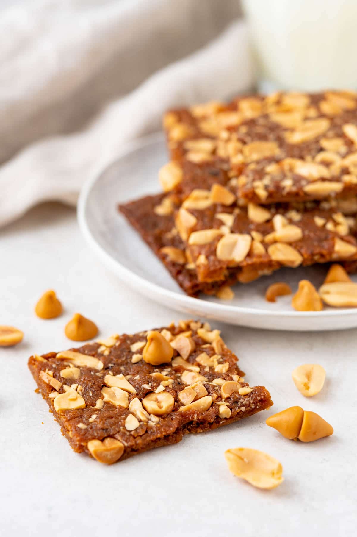 a plate with the peanut bars and extra nuts on top.