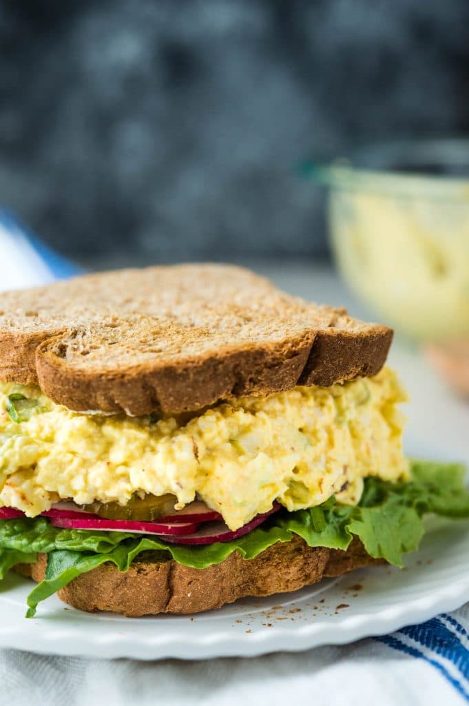 an egg salad sandwich on whole wheat toast. 