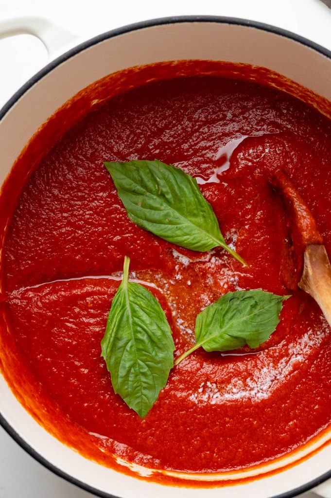 Prepared pomodoro sauce with butter and basil leaves.