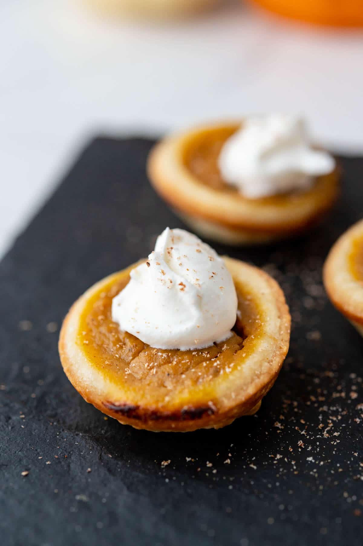 mini pumpkin tartlet with whipped cream.