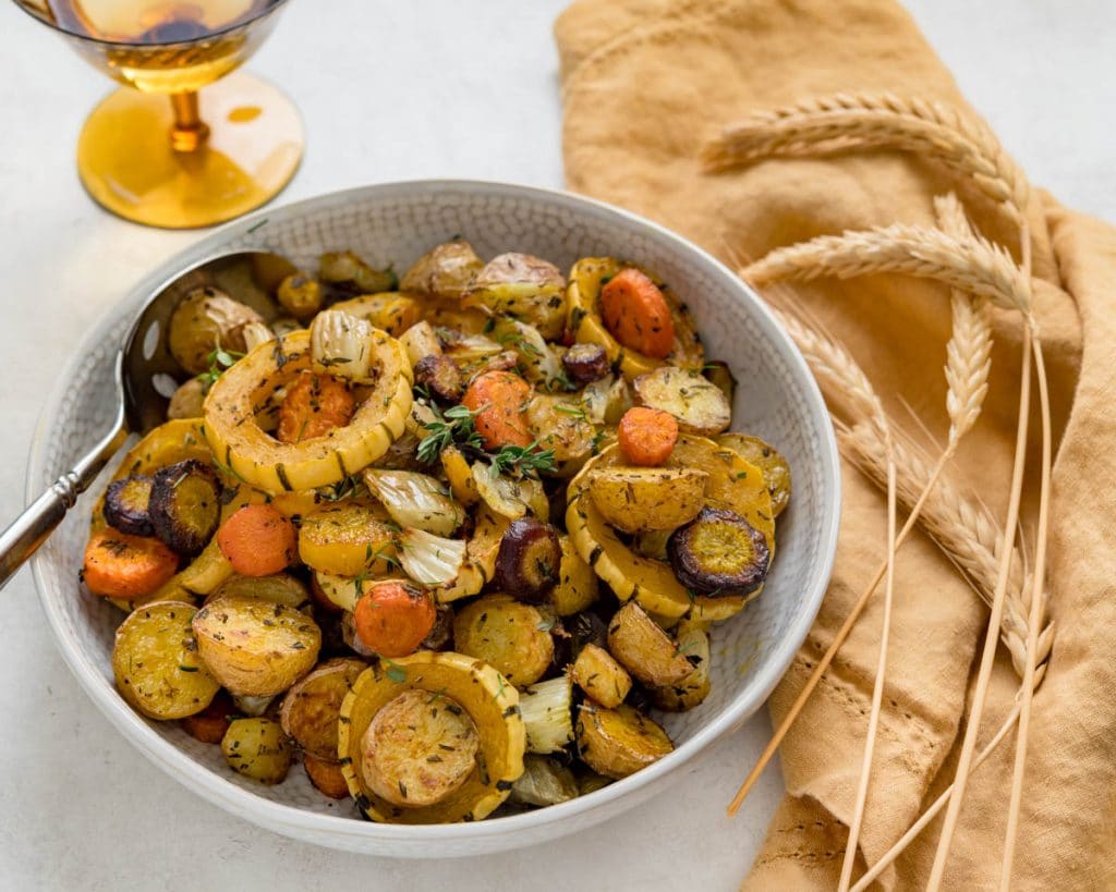 a serving bowl filled with roasted root vegetables. 