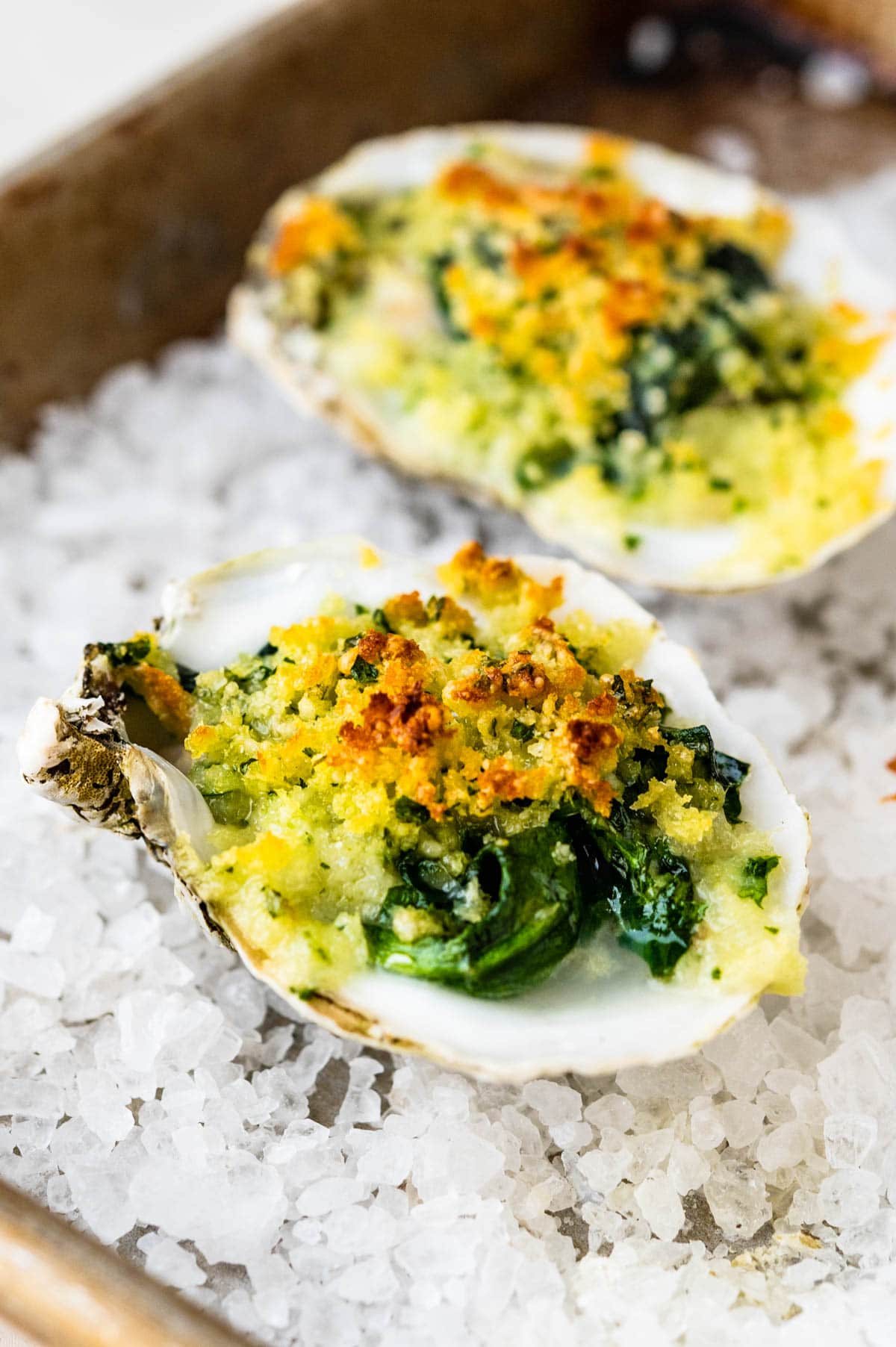 A closeup recipe of baked Rockefeller oysters recipe.