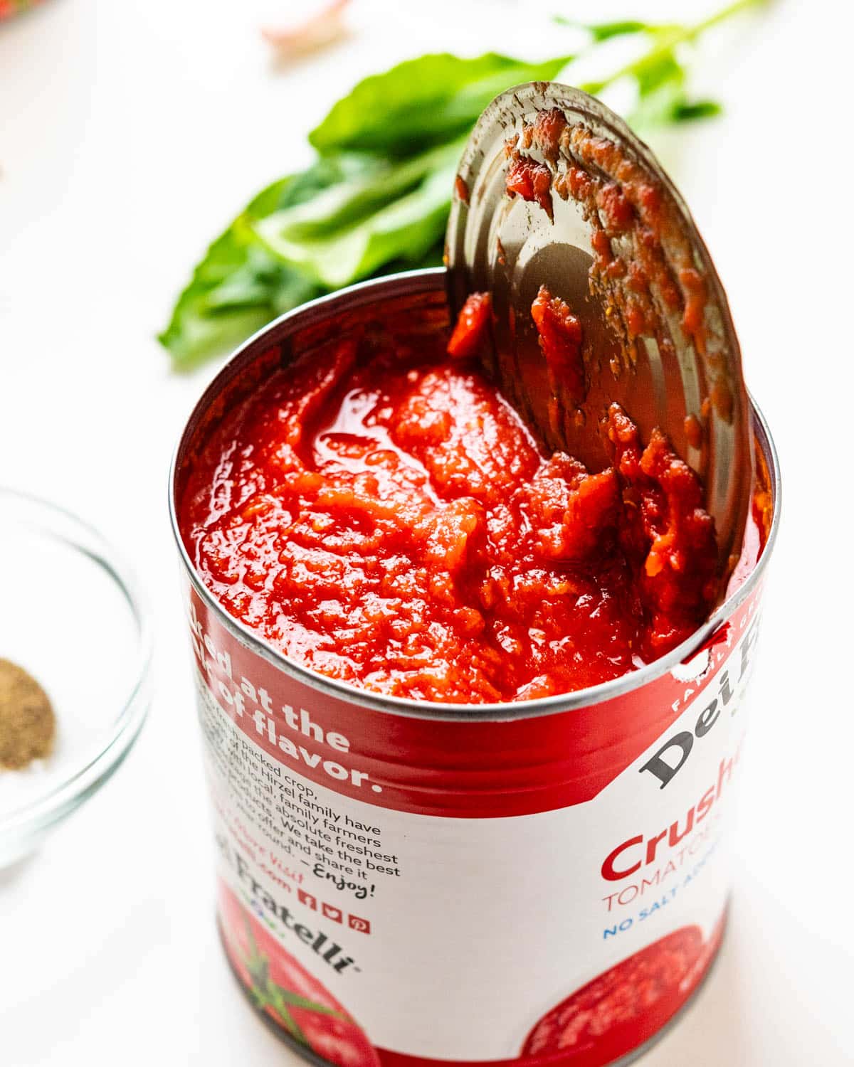 Opening a can of crushed tomatoes.