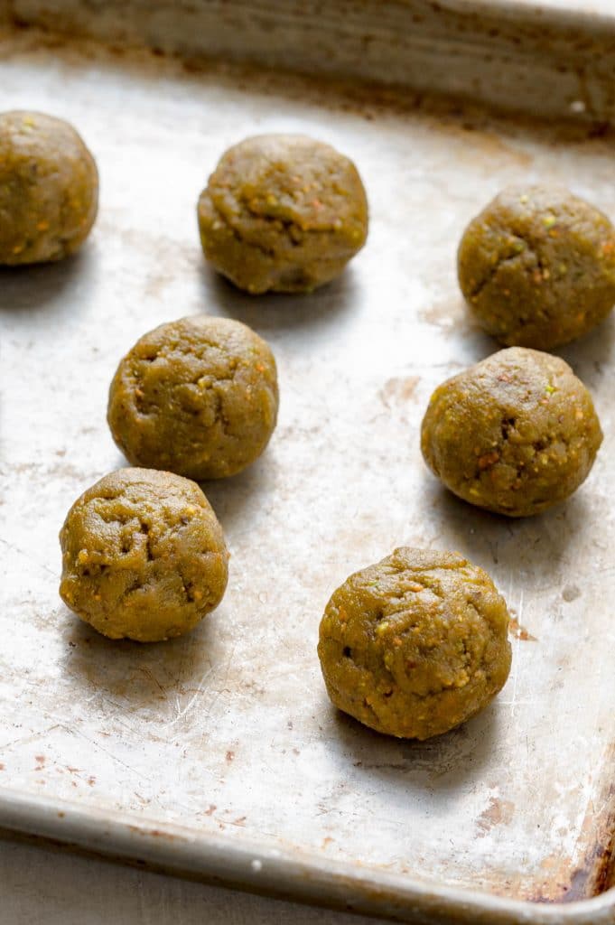 rolling pistachio truffles into balls.