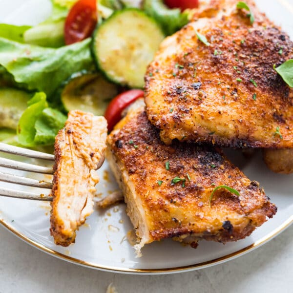 baked chicken thighs with a salad.