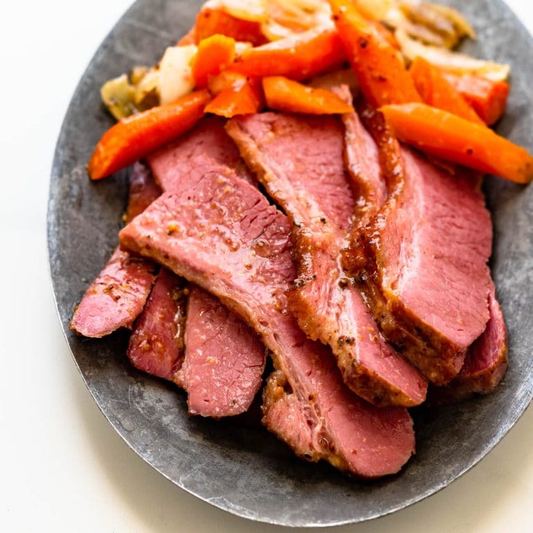 glazed corned beef cooked in the oven with carrots and onions.