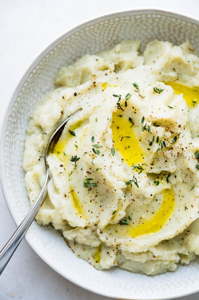 Serve the mashed cauliflower with roasted garlic garnished with a bit of olive oil and fresh thyme, salt and pepper.