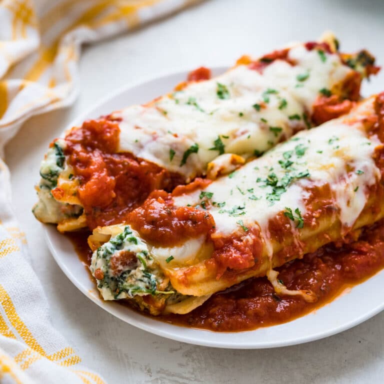 spinach manicotti on a plate.