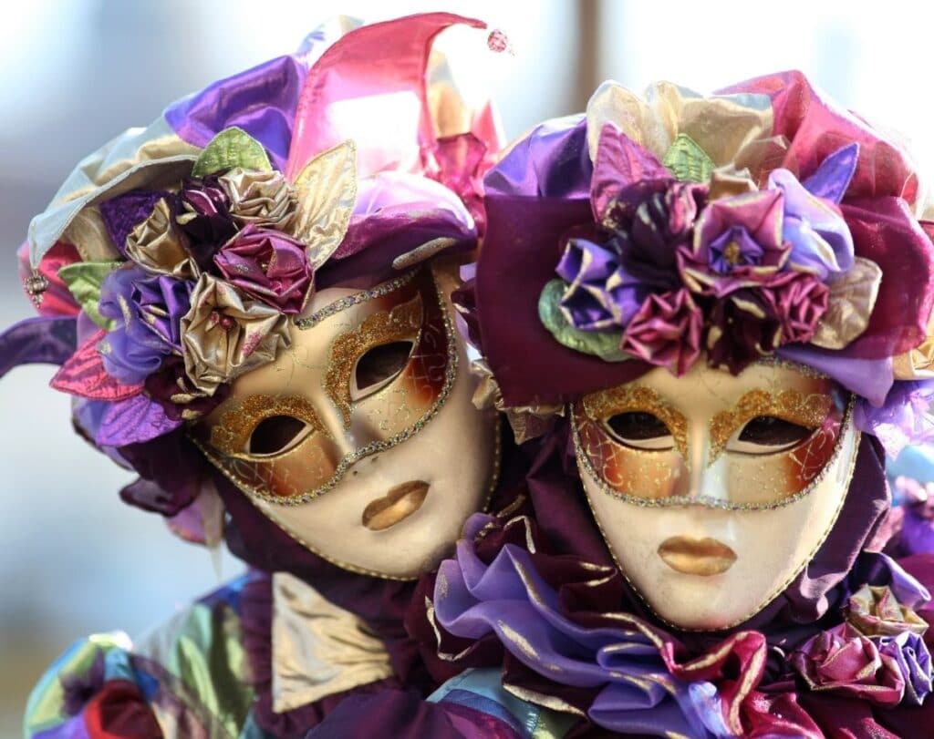 revelers dressed in costumes and masks for Mardi gras.
