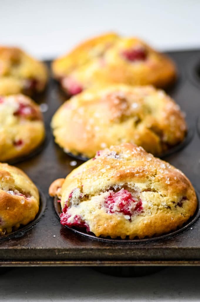 raspberry muffins in a muffin tin.