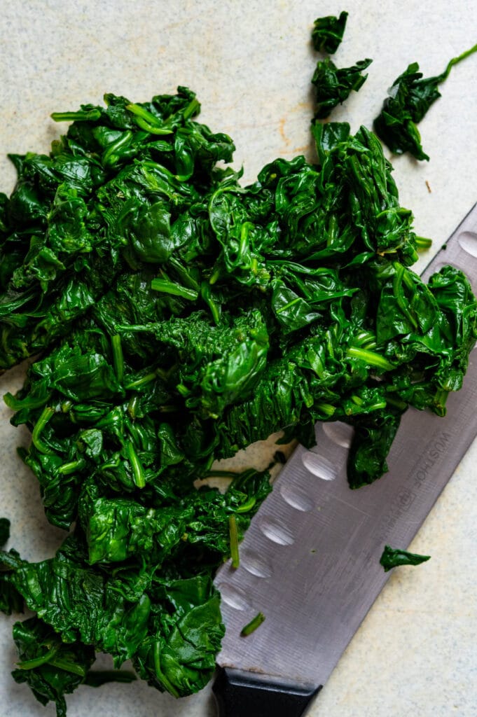 chop the spinach on a cutting board.