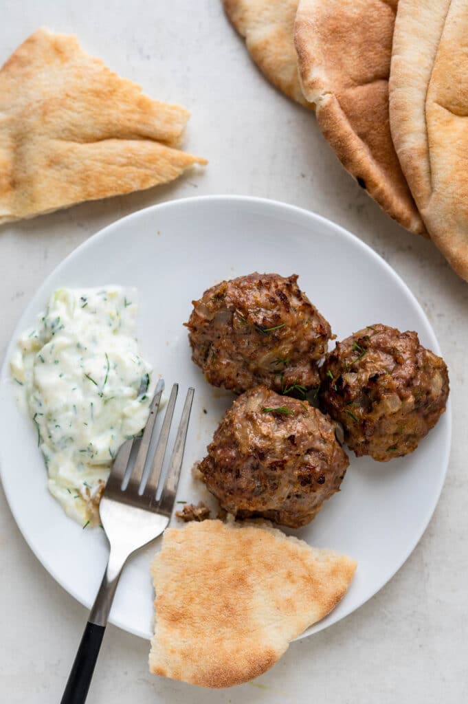 serving the meatballs with tzatziki and pita.