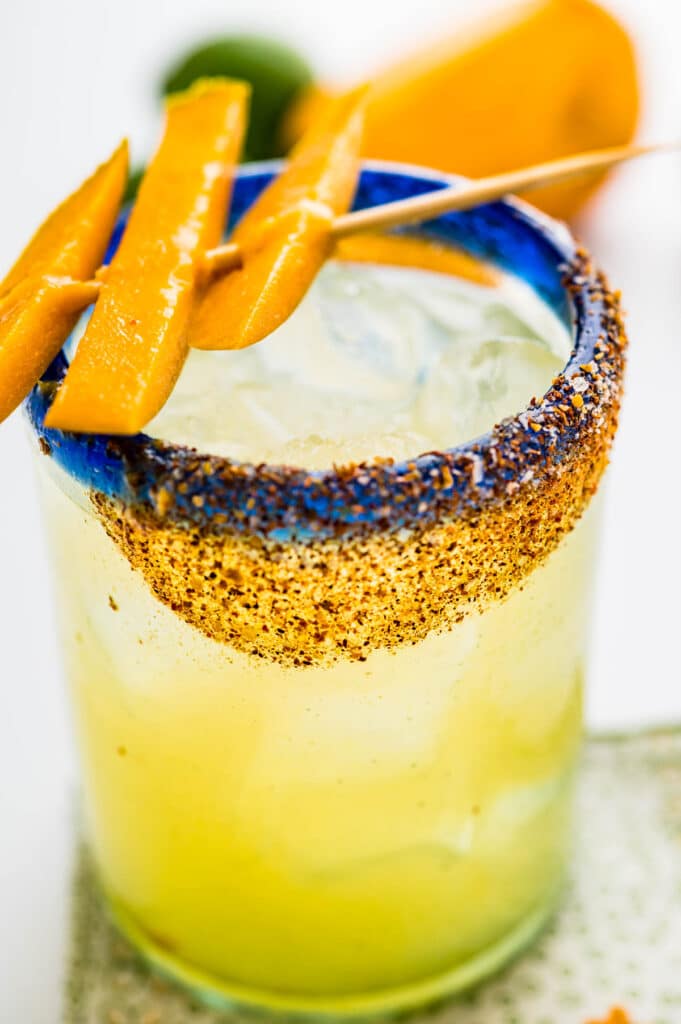 garnish the cocktail with fresh mango slices.