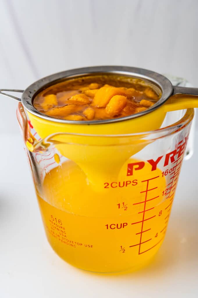 strain the mango syrup using a funnel and fine mesh strainer.