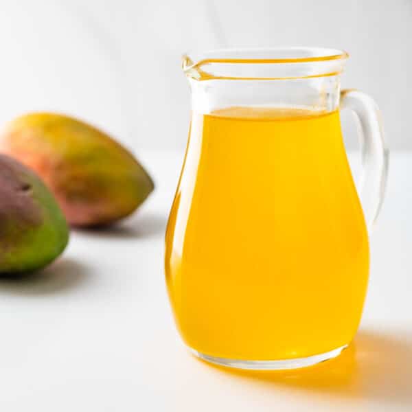 mango simple syrup in a pitcher.