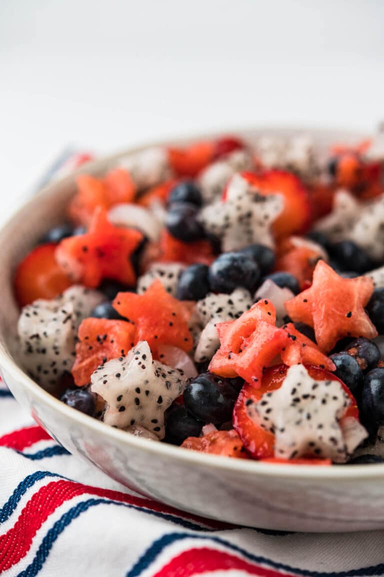 A bowl of red white and blue fruit salad.